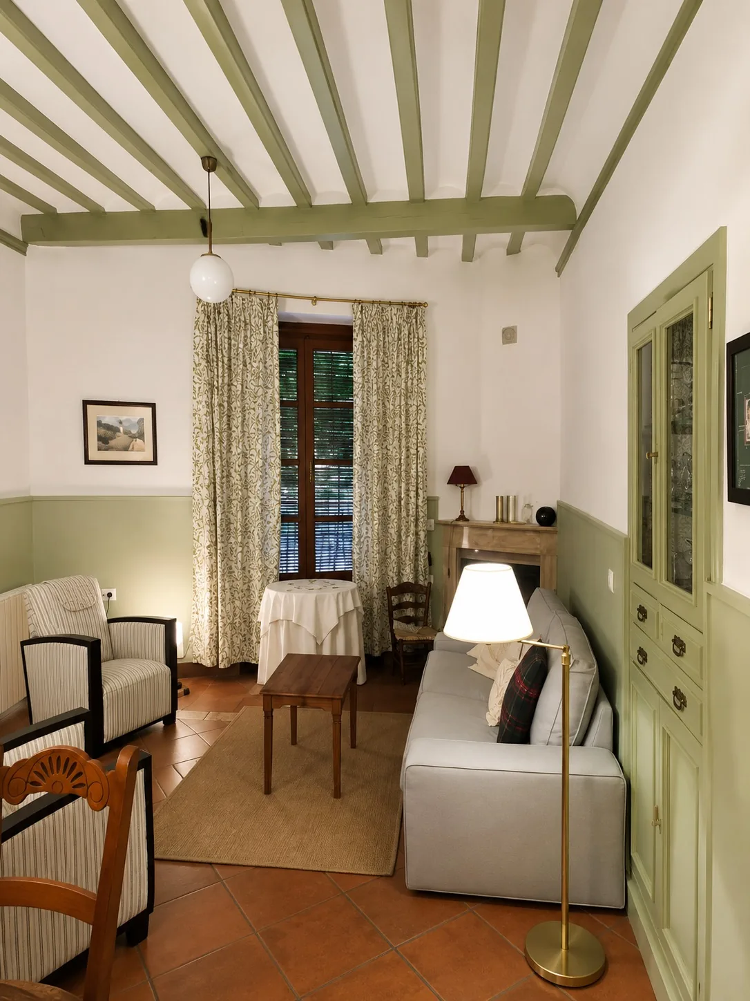 Salón pintado en dos tonos, verde y blanco hueso, con vigas a juego